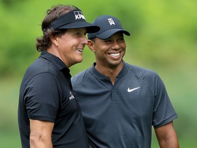 Phil Mickelson (left) and Tiger Woods smile during a practice round prior to the World Golf Championships-Bridgestone Invitational at Firestone Country Club South Course on August 1, 2018 in Akron, Ohio. (Sam Greenwood/Getty Images)