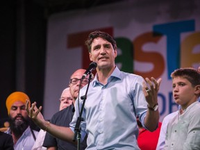 Prime Minister Justin Trudeau delivers remarks on the first day of the Taste of the Danforth street festival in Toronto, on Friday, August 10, 2018.