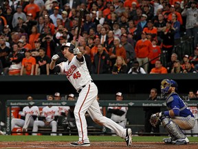 Mark Trumbo of the Baltimore Orioles follows through after hitting a walk-off home run against the Toronto Blue Jays during the eleventh inning in their Opening Day game at Oriole Park at Camden Yards on April 3, 2017 in Baltimore, Md.