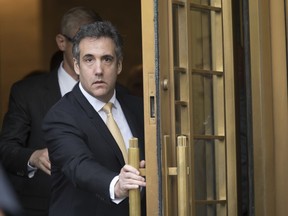 Michael Cohen leaves Federal court, Tuesday, Aug. 21, 2018, in New York.