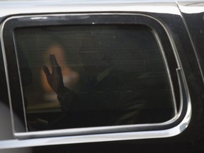 Republican presidential nominee Donald Trump waves from his limo as he leaves Trump Tower in New York after a meeting with black and Latino activists on Aug. 25, 2016.