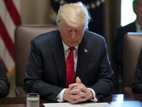 U.S. President Donald Trump prays during a Cabinet Meeting in the Cabinet Room of the White House in Washington, D.C., on Aug. 16, 2018.