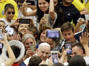Pope Francis is cheered by faithful as he arrives in the Paul VI hall at the Vatican for his the weekly general audience, Wednesday, Aug. 1, 2018. (AP Photo/Gregorio Borgia)