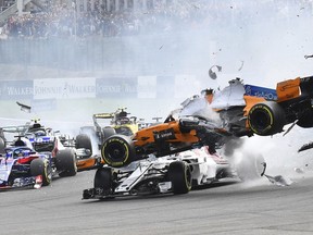 Mclaren driver Fernando Alonso of Spain, right, crashes at the start of the Belgian Formula One Grand Prix in Spa-Francorchamps, Belgium, Sunday, Aug. 26, 2018.