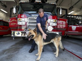 Draper firefighter Patrick Cullen with his new dog, Mendo, at Fire station 21 in Draper on Monday, Aug. 27, 2018.