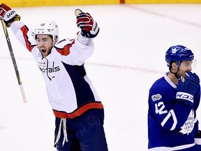 In this April 19, 2017, file photo, Washington Capitals right wing Tom Wilson celebrates his goal as Toronto Maple Leafs centre Tyler Bozak skates past during first period NHL hockey round one playoff action in Toronto.