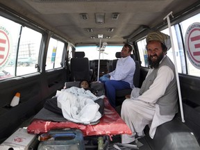 An injured boy rides in an ambulance on the Ghazni highway, in Maidan Shar, west of Kabul, Afghanistan, Monday, Aug. 13, 2018.