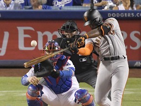 In this Aug. 15, 2018, file photo, San Francisco Giants' Andrew McCutchen hits a three-run home run during a game in Los Angeles.