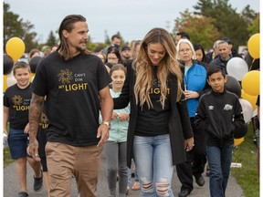 Erik and Melinda Karlsson, representing their organization, Can't Dim My Light, lead their first fundraising event called Walk of Light, at the Kanata Recreations Complex on Sunday.