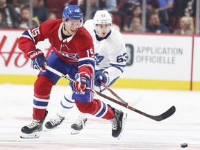 Montreal Canadiens' Jesperi Kotkaniemi head-mans the puck in front of Toronto Maple Leafs Tyler Ennis during second period in Montreal on Wednesday, September 26, 2018.