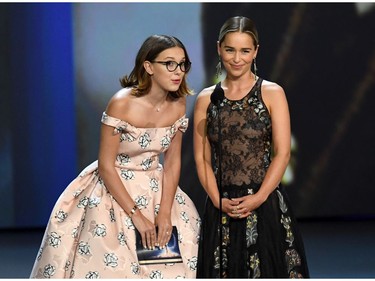 Millie Bobby Brown (L) and Emilia Clarke speak onstage during the 70th Emmy Awards at Microsoft Theater on September 17, 2018 in Los Angeles, California.