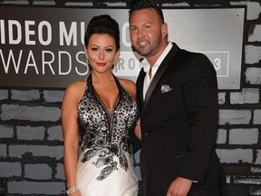 TV personalities Jenni 'Jwoww' Farley (L) and Roger Mathews attend the 2013 MTV Video Music Awards at the Barclays Center on August 25, 2013 in the Brooklyn borough of New York City.