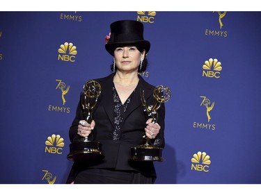 Amy Sherman-Palladino poses in the press with the awards for outstanding writing for a comedy series and for outstanding directing for a comedy series for "The Marvelous Mrs. Maisel" at the 70th Primetime Emmy Awards on Monday, Sept. 17, 2018, at the Microsoft Theater in Los Angeles.