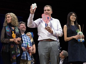 Hanyu Liang, right, and her team receive the Ig Nobel award for economics during ceremonies at Harvard University in Cambridge, Mass., Thursday, Sept. 13, 2018. (AP Photo/Michael Dwyer)