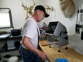 In this Sept. 25, 2018 photo, Myron Schlafman demonstrates how his arm got caught in the meat mixer Jamestown, N.D.