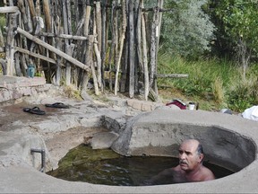 In this Aug. 26, 2018, photo, Joseph Arellanes, of Las Vegas, soaks in the hot springs at the United World College-USA in Montezuma, N.M.  (Gwen Albers/The Daily Optic via AP)