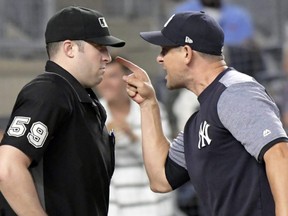 Yankees manager Aaron Boone, right, confronts umpire Nic Lentz before being tossed during a game against the Tigers at Yankee Stadium in New York, Friday, Aug. 31, 2018.