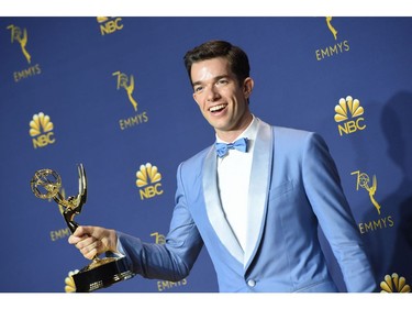John Mulaney pose with his Emmy for outstanding writing for a variety special during the 70th Emmy Awards at the Microsoft Theatre in Los Angeles, California on September 17, 2018.