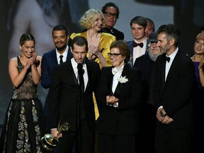 Writer-producer D.B. Weiss (C-L) and the cast of "Game of Thrones" accept the award Outstanding Drama series  onstage during the 70th Emmy Awards at the Microsoft Theatre in Los Angeles, California on September 17, 2018.
