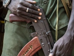An army commander stands with an rifle during a release ceremony for child soldiers in Yambio, South Sudan, on February 7, 2018.