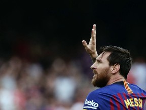 Barcelona's Lionel Messi celebrates scoring the opening goal during a Spanish La Liga soccer match between Barcelona and Huesca at the Camp Nou stadium in Barcelona, Spain, Sunday Sept. 2, 2018.