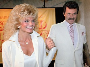 In this March 27, 1987, file photo, Burt Reynolds, right, holds hands with Loni Anderson at luncheon in Los Angeles.