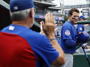 Chicago Cubs first baseman Anthony Rizzo (44) looks at manager Joe Maddon, left, as Maddon claps for the team at the start of a baseball game against the Washington Nationals, Thursday, Sept. 13, 2018, at Nationals Park in Washington. (AP Photo/Jacquelyn Martin)