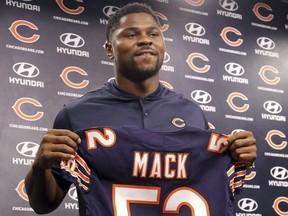 In this Sept. 2, 2018, file photo, newly acquired Chicago Bears player Khalil Mack displays his jersey after speaking to the media during an NFL football news conference, in Lake Forest, Ill.