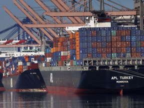 FILE - In this Feb. 23, 2015 file photo, container ships wait to be unloaded at the Port of Los Angeles. China has raised tariffs on $60 billion of U.S. imports in an escalation of their trade battle following a deadline for President Donald Trump's latest increase.