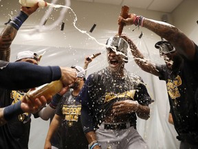 Milwaukee Brewers' Keon Broxton is doused as he celebrates with teammates after a 2-1 victory over the St. Louis Cardinals Wednesday, Sept. 26, 2018, in St. Louis.