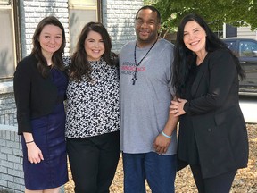 In this photo provided by the law firm Lassiter and Cassinelli, John Brown, second from right, poses with Midwest Innocence Project investigator Blair Johnson, MIP attorney Rachel Wester, and attorney Erin Cassinelli after Brown was released from prison on Wednesday, Sept. 19, 2018, in Little Rock, Ark.