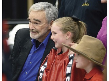 In this Aug. 11, 2018 photo, Burt Reynolds with Maecee Crumley and Branson Crumley pose as the Crumley family takes a few shots at Pigeon Forge's Bubba Fest in Pigeon Forge, Tenn.