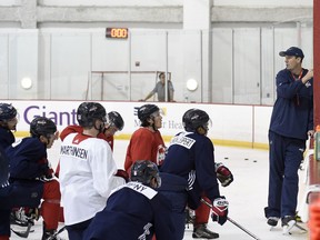 Washington Capitals head coach Todd Reirden, right, speaks to his players during NHL hockey training camp, Friday, Sept. 14, 2018, in Arlington, Va.