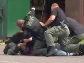 Marion County Sheriff's deputies pile on Kevin Straw during his arrest. (YouTube screen grab)