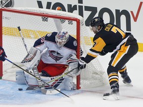Pittsburgh Penguins' Matt Cullen shoots on Columbus Blue Jackets goaltender Joonas Korpisalo as the goal net post starts to lift during the first period of an NHL preseason hockey game, Saturday, Sept. 22, 2018, in Pittsburgh.