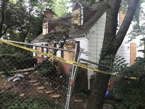 In this Aug. 18, 2018, photo, police tape surrounds the house where Askia Khafra died in a fire while digging underground tunnels for a secretive campaign to build a nuclear bunker in Bethesda, Md. /