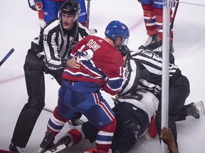 Montreal Canadiens' Max Domi is pulled away by linesman Ryan Daisy after a brief fight with Florida Panthers' Aaron Ekblad in Montreal on Wednesday, September 19, 2018. (THE CANADIAN PRESS/Paul Chiasson)
