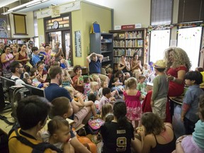 Vanessa Carr, right, reads to children during Drag Queen Story Time at the Alvar Library in New Orleans on Saturday, Aug. 25, 2018.