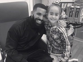 This Monday, Aug, 20, 2018 photo provided by the rapper Drake shows him posing with Sofia Sanchez, at Lurie Children's Hospital in Chicago. Drake surprised her after she recorded a video of herself dancing to the rapper's "In My Feelings" and invited him to her birthday party. Sanchez is awaiting a heart transplant. (OVO/Drake via AP)