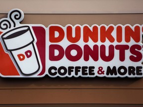 In this Jan. 22, 2018, file photo shows the Dunkin' Donuts logo on a shop in Mount Lebanon, Pa.