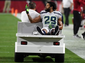 Defensive back Earl Thomas of the Seattle Seahawks gestures as he leaves the field on a cart after being injured against the Arizona Cardinals at State Farm Stadium on September 30, 2018 in Glendale, Arizona. (Norm Hall/Getty Images)