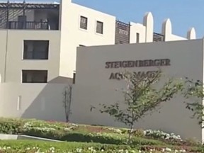 FILE - This Friday, Aug. 24, 2018 file photo taken from video shows the exterior of the Steigenberger Aqua Magic Hotel in Hurghada, Egypt. Egypt's chief prosecutor said Wednesday. Sept. 12, 2018 that tests showed that e.coli bacteria were behind the death of two British tourists in the hotel in the Red Sea resort of Hurghada. Travel company Thomas Cook said last week that there was a "high level of e.coli and staphylococcus bacteria" at the Steigenberger Aqua Magic Hotel where John and Susan Cooper, a couple in their 60s, died Aug. 21. (AP Photo, File) ORG XMIT: CAITH103