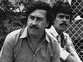 In this 1983 file photo, Medellin drug cartel boss Pablo Escobar watches a soccer game in Medellin, Colombia.