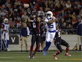 Ottawa Redblacks defensive back Antoine Pruneau steps in front of Montreal Alouettes wide receiver B.J. Cunningham to make an interception during first half CFL action in Ottawa on Friday, Aug. 31, 2018.
