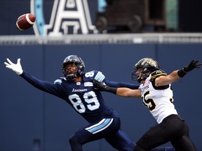 Toronto Argonauts wide receiver Duron Carter (89) reaches for an overthrown ball against Hamilton Tiger-Cats defensive back Mike Daly (35) during first half CFL football action against the Hamilton Tiger-Cats, in Toronto, Saturday, Sept. 8, 2018. THE CANADIAN PRESS/Cole Burston
