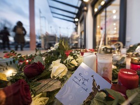 In this Dec. 28, 2017 file photo a card with a writing "angels are forever" is placed between candles in Kandel, western Germany, at the site where 15-year-old Mia was stabbed earlier.