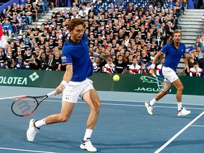 France's Nicolas Mahut, left, and Julien Benneteau play Spain's Marcel Granollers, and Feliciano Lopez during their Davis Cup semifinals double match, in Lille, northern France, Saturday, Sept. 15, 2018.