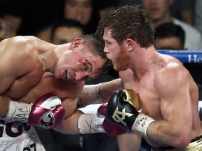 Canelo Alvarez, right, of Mexico, lands a punch on WBC/WBA middleweight champion Gennady Golovkin, of Khazakstan, during their title boxing fight at T-Mobile Arena in Las Vegas, Saturday, Sept. 15, 2018.