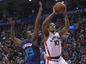 Toronto Raptors' DeMar DeRozan, right, shoots over Charlotte Hornets' P.J. Hairston in Toronto on Friday January 1, 2016. (THE CANADIAN PRESS/Chris Young)