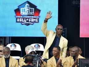 In this Aug. 2, 2014, file photo, enshrinee Eric Dickerson is introduced during the Pro Football Hall of Fame enshrinement ceremony, in Canton, Ohio. A group of Pro Football Hall of Famers is demanding health insurance coverage and a share of NFL revenues or else those former players will boycott the induction ceremonies. In a letter sent to NFL Commissioner Roger Goodell, NFLPA Executive Director DeMaurice Smith and Hall of Fame President David Baker -- and obtained by The Associated Press -- 21 Hall of Fame members cited themselves as "integral to the creation of the modern NFL, which in 2017 generated $14 billion in revenue." Among the signees were Eric Dickerson.
